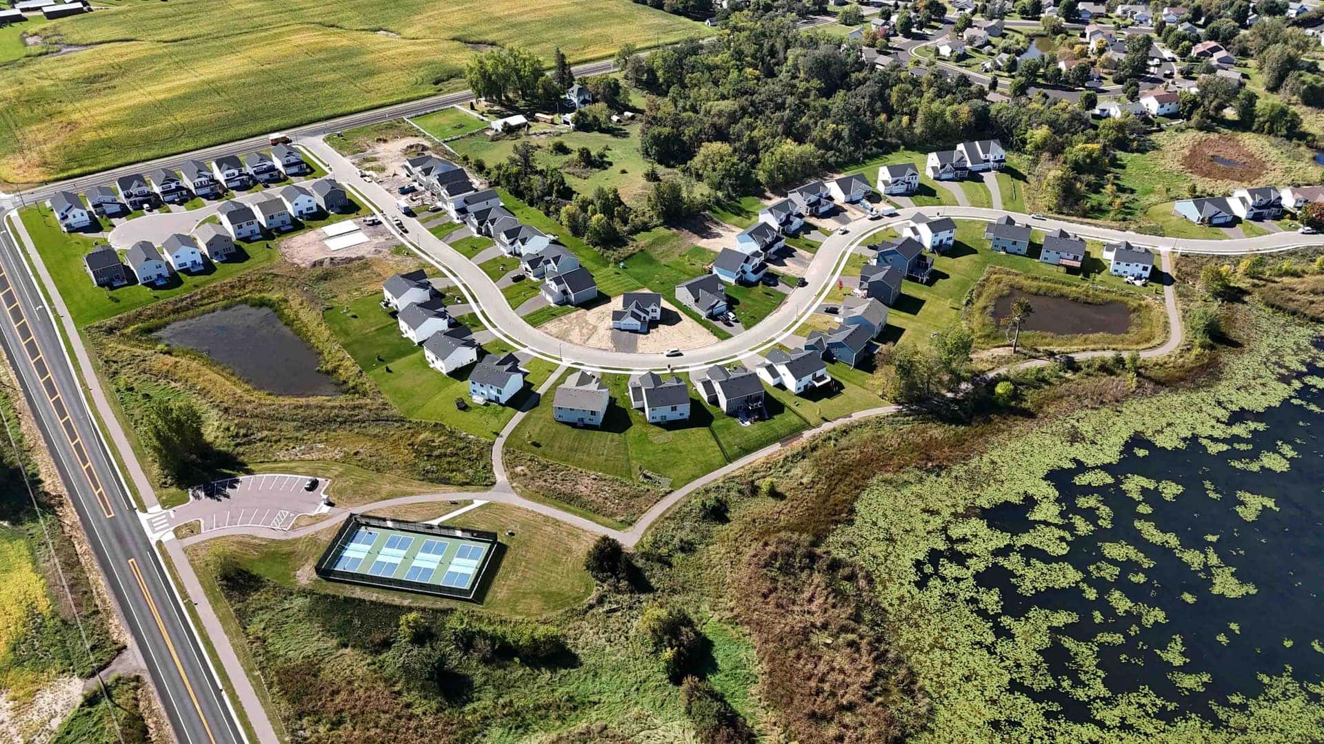 Aerial view of the Greenbriar Hills neighborhood in Buffalo, MN — rolling land, ponds, and custom homesites