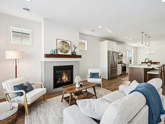 Bright open-concept living room and kitchen in a custom Buffalo, MN home by Nordic Homes